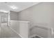 Upstairs hallway with carpet, leading to bedrooms and staircase at 6292 Twain St # 101, Orlando, FL 32835