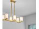 Modern gold chandelier with white glass shades at 9818 Introduction Way, Orlando, FL 32832