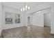 Bright dining room with hardwood floors and a modern chandelier at 9818 Introduction Way, Orlando, FL 32832