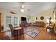 Living room with vaulted ceiling, hardwood floors, and comfy seating at 1208 Hilltop Dr, Mount Dora, FL 32757