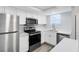 Updated kitchen with stainless steel appliances and white cabinets at 1500 Gay Rd # 7A, Winter Park, FL 32789