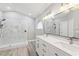 Modern bathroom with double vanity, marble shower, and gray floors at 1623 Walkerton Ct, Winter Garden, FL 34787