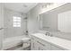 Updated bathroom with white vanity, bathtub, and marble tile at 1623 Walkerton Ct, Winter Garden, FL 34787