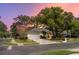 House exterior at sunset with landscaping at 1623 Walkerton Ct, Winter Garden, FL 34787