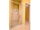 Stand-up shower with glass enclosure in a yellow bathroom at 2485 Huron Cir, Kissimmee, FL 34746