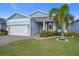 Two-story home with light blue siding, white garage door and landscaping at 3288 Sailing Pier Ave, Winter Garden, FL 34787