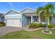 One-story light blue house with white garage door and landscaping at 3288 Sailing Pier Ave, Winter Garden, FL 34787