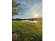 Scenic view of a lake at sunset with lush green grass at 3812 Fescue St, Clermont, FL 34714