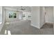 Bright and airy living area with neutral tones and access to other rooms at 4099 Old Canal St, Leesburg, FL 34748