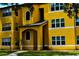 Bright yellow building exterior with walkway at 4572 Commander Dr # 1227, Orlando, FL 32822