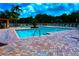 Community pool with brick patio and chairs at 4572 Commander Dr # 1227, Orlando, FL 32822
