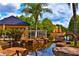 Community pond with gazebo and landscaping at 4572 Commander Dr # 1227, Orlando, FL 32822