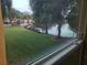 View of lake from window, green space, and buildings at 4572 Commander Dr # 1227, Orlando, FL 32822