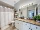Bathroom with granite countertops, white cabinets, and a shower/tub combo at 5269 Wellington Park Cir # 23, Orlando, FL 32839