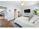 Bright bedroom with king-size bed, hardwood floors, and access to bathroom at 5269 Wellington Park Cir # 23, Orlando, FL 32839