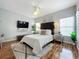 Relaxing main bedroom with tufted headboard and wood floors at 5269 Wellington Park Cir # 23, Orlando, FL 32839