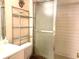 Simple bathroom with shower stall and storage shelf at 6040 Amberly Ave # F54, Orlando, FL 32822