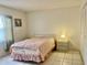 Bright bedroom with double bed and nightstand at 6040 Amberly Ave # F54, Orlando, FL 32822