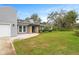 Modern gray house with stone accents and a neat lawn at 6648 Parson Brown Dr, Orlando, FL 32819