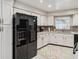 Kitchen features black appliances and white cabinets at 8916 Brackenwood Dr, Orlando, FL 32829