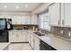 Well-equipped kitchen featuring white cabinets and granite countertops at 8916 Brackenwood Dr, Orlando, FL 32829