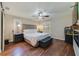 Bright bedroom with a king-size bed and wood flooring at 9782 County Road 209, Wildwood, FL 34785