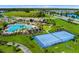 Community tennis courts and pool with clubhouse in background at 12128 Illustration Dr, Orlando, FL 32832