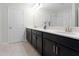 Double vanity bathroom with a large mirror at 12128 Illustration Dr, Orlando, FL 32832
