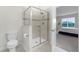 Bathroom with toilet, shower, and view into a bedroom at 12128 Illustration Dr, Orlando, FL 32832