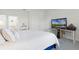 Main bedroom with large bed, en-suite bathroom access, and a workspace at 12128 Illustration Dr, Orlando, FL 32832