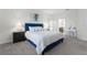 Spacious bedroom with a blue upholstered bed and bedside tables at 12128 Illustration Dr, Orlando, FL 32832