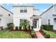 Two-story house featuring a landscaped lawn, brick walkway and a blue front door at 12128 Illustration Dr, Orlando, FL 32832
