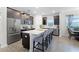 Modern kitchen with stainless steel appliances and an island with seating at 12128 Illustration Dr, Orlando, FL 32832
