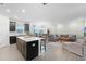 Open floor plan with kitchen island and spacious living room at 12128 Illustration Dr, Orlando, FL 32832