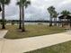 Serene lakefront park with palm trees, benches, and a covered pavilion at 12128 Illustration Dr, Orlando, FL 32832