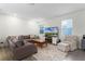 Living room with sectional sofa, coffee table, and armchair at 12128 Illustration Dr, Orlando, FL 32832
