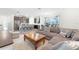 Open living area featuring a large sectional sofa and a wooden coffee table at 12128 Illustration Dr, Orlando, FL 32832
