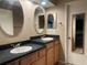 Clean bathroom with double sinks and oval mirrors at 1310 Stearman Ct # 4, Orlando, FL 32825