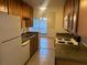Kitchen with wood cabinets, appliances, and breakfast bar at 1310 Stearman Ct # 4, Orlando, FL 32825