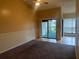 Spacious living room with carpeting and sliding glass doors to balcony at 1310 Stearman Ct # 4, Orlando, FL 32825