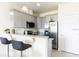 Modern kitchen with granite countertops, stainless steel appliances, and breakfast bar at 1784 Coriander Dr, Kissimmee, FL 34759