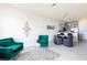 Spacious living room features teal velvet armchairs and a dining area at 1784 Coriander Dr, Kissimmee, FL 34759