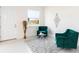 Cozy sitting area with two teal armchairs and a small glass-top coffee table at 1784 Coriander Dr, Kissimmee, FL 34759