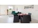 Open living area with teal armchairs, glass top coffee table, and dining table at 1784 Coriander Dr, Kissimmee, FL 34759