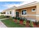 Tan colored stucco exterior with covered entry and landscaping at 1788 Coriander Dr, Kissimmee, FL 34759