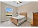 Cozy bedroom with a vintage bed frame and a large window at 1801 Jainic Loop, Apopka, FL 32712