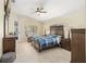 Spacious Primary bedroom with large bed, dresser, and access to backyard at 1855 S Lehigh Dr, Deltona, FL 32738