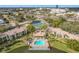 Aerial view of community with pool, tennis courts, and lake at 2 Escondido Cir # 190, Altamonte Springs, FL 32701