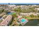 Aerial view showing community pool and tennis courts near a lake at 2 Escondido Cir # 190, Altamonte Springs, FL 32701