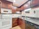 Updated kitchen with dark wood cabinets and granite at 2 Escondido Cir # 190, Altamonte Springs, FL 32701